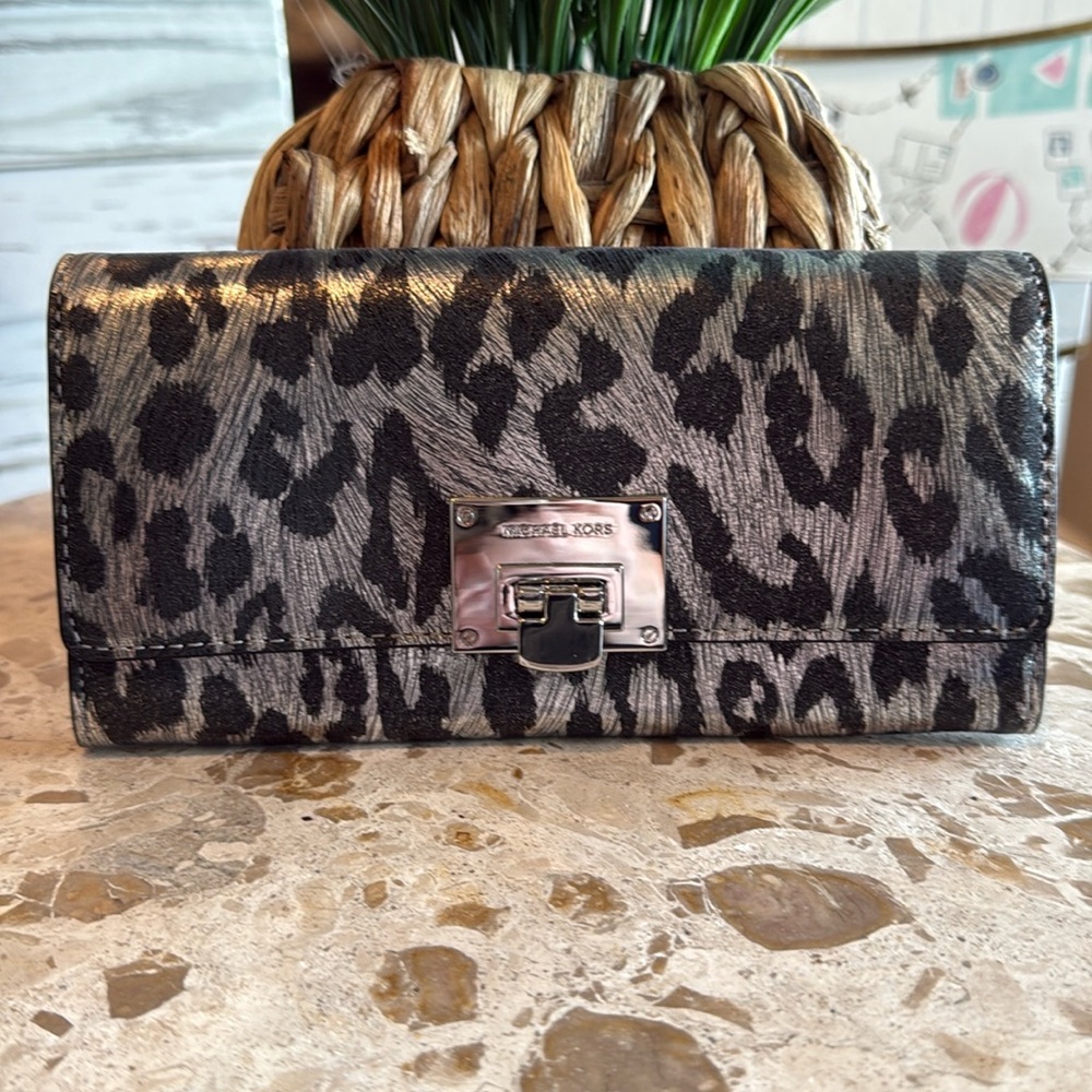 Michael Kors silver and black leopard leather wallet. Silver buckle closure.